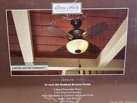 Box front displaying Allen + Roth Laralyn 32-inch oil-rubbed bronze ceiling fan with amber glass bowl light