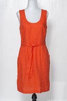 Front view of orange linen dress on mannequin