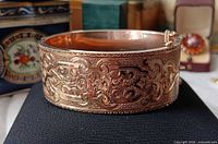 Side view showing ornate engraved pattern on bracelet exterior