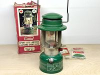 Front view of Coleman 321C lantern with box and accessories