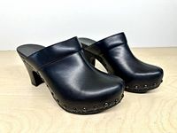 pair of black leather clogs three-quarter view showing uppers and stud detail