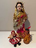 Group view of all three dolls showing relative sizes and costumes