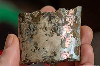 cylindrical ammonite fragment showing iridescent sutures