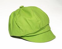 Profile view of lime green cotton cap with brim and button top