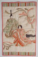 Full view of quilted wall hanging showing figures, ribbon and border