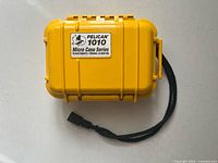 Top view of yellow Pelican 1010 Micro Case with strap attached