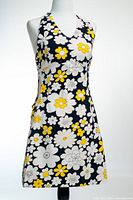 Front view of halter mini dress on mannequin displaying floral print