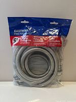 Front of sealed package showing Eastman Steel-Flex branding and coiled stainless braided hoses
