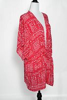 Front angled view of red patterned Victoria's Secret tie-front kimono cover up on mannequin