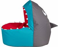 Side view of shark-shaped bean bag chair showing teal exterior, red interior, white teeth