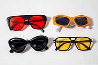 All four pairs laid flat showing frame styles and lens colors