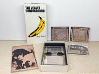 Front of slipcase, booklet, three CDs and inner tray visible