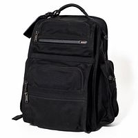 Front view of black TUMI backpack showing overall design and front pockets