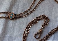 Close-up of slider with turquoise and pearl and dog-clip clasp on gold-plated chain