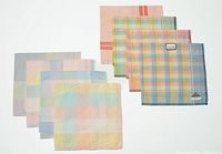 All eight pastel plaid cotton hankies laid flat
