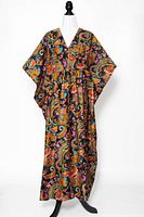 Front view of vintage paisley muumuu dress on mannequin