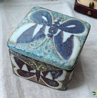 Angled view showing butterfly decoration on lid and side of ceramic box