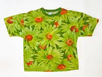 Front view of green daisy print Benetton T-shirt laid flat