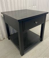 Full view of bedside table showing drawer and shelf