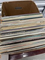 Open box showing stacked vinyl record albums
