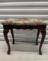 Front view of bench showing legs and upholstery