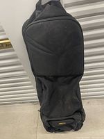 Full view front of black Bag Boy golf travel bag standing upright