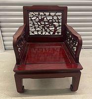 Front view of redwood Chinese style low chair showing carved backrest