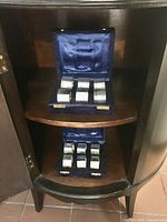 both open cases with napkin rings on cabinet shelves