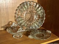 All three glass pieces grouped on shelf