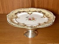 Entire plate on sterling pedestal base, full view