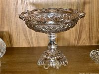 Side view of entire pressed glass pedestal comport on shelf