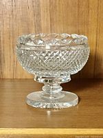 Full view of crystal footed bowl on wood surface