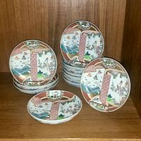 Group shot of stacked and leaning Imari bowls on shelf