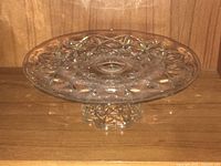 Overall view of pressed glass pedestal cake stand on shelf