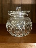 Front view of clear cut crystal pot with lid showing pattern and knob