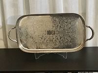 Front overhead view of entire tray showing ornate engraved pattern and handles