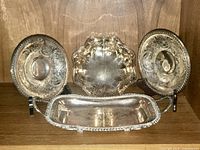 All four silver-plated pieces on shelf