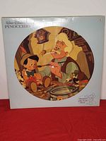 Front of jacket displaying Geppetto artwork through die-cut window