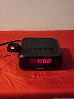 Front view showing LED display 1:02 and projector module