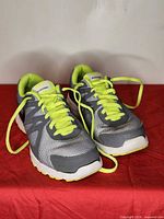 Oblique view of both shoes showing uppers, laces, and general wear