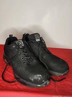 Three-quarter view of both sneakers showing uppers, laces and toe scuffs