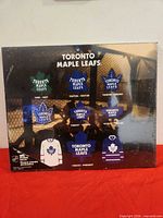 Front of plaque displaying historic Toronto Maple Leafs logos and jerseys