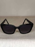 Front view of black oversized rectangular sunglasses