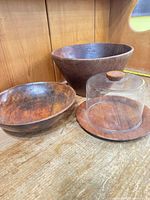 Group view of two bowls, shallow dish, and base with glass dome