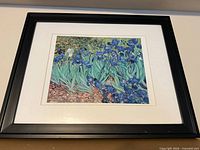 Black-framed print of blue and violet irises with white mat
