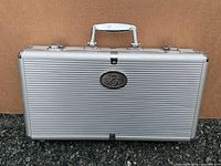 Closed aluminum case displaying Budweiser emblem and handle