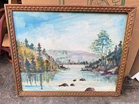 Front view of framed oil landscape painting