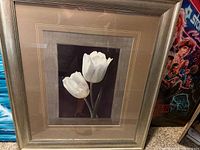 Front view showing framed, matted picture of two white flowers
