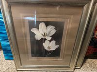 Front view showing white flower print, matting, frame