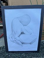 Front view of mounted graphite hand study drawing